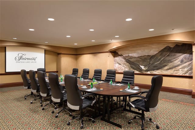 Elegant meeting room at Fairmont Hotels, featuring a spacious oval table for corporate events.