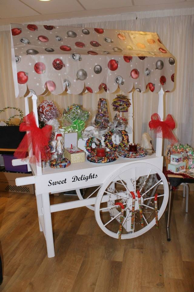 Dessert cart "Sweet Delights" with colorful treats for weddings and parties.