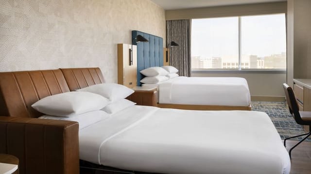 Hotel room with two beds and modern decor, perfect for meetings in San Jose Marriott.