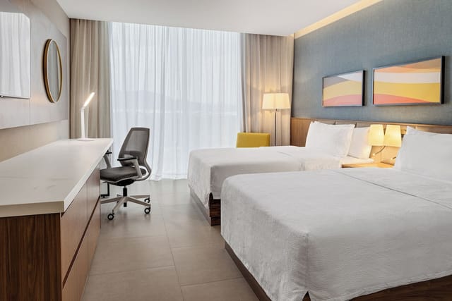 Modern meeting room with twin beds for events at Hilton Garden Inn San Jose Airport.