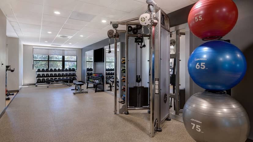 Conference room with fitness gear at Embassy Suites for wellness retreats and corporate events.