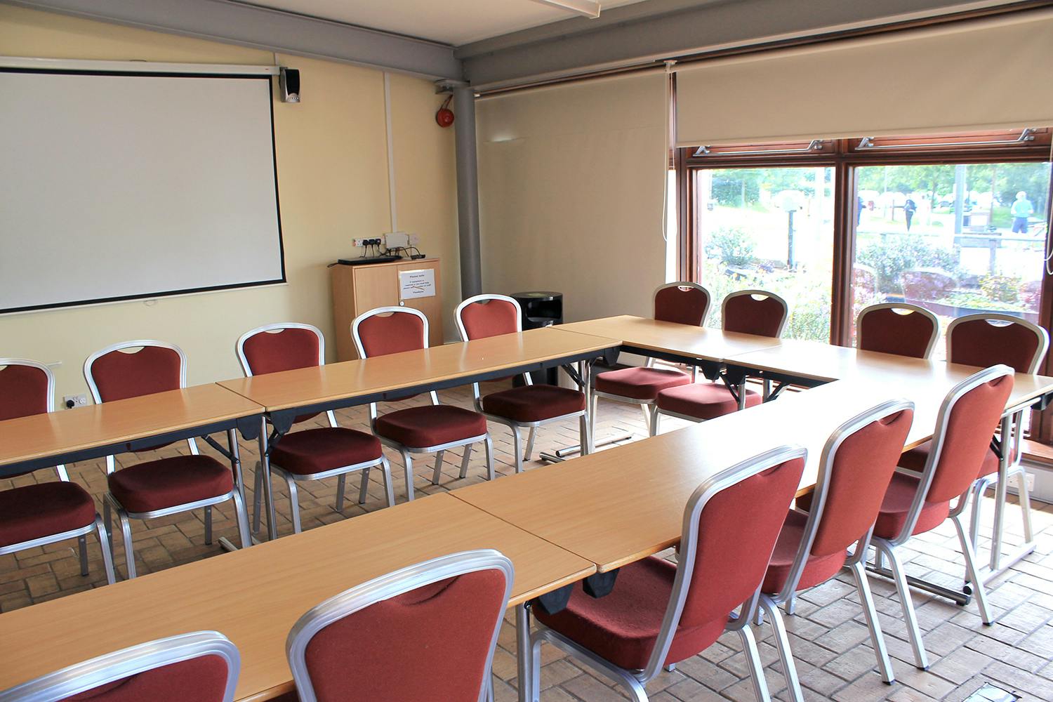 Meeting room at The Folly, U-shaped tables, ideal for collaborative sessions and presentations.