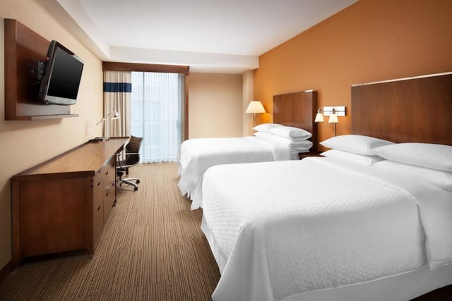 Modern conference room at Four Points by Sheraton San Jose Airport with two beds, ideal for events.