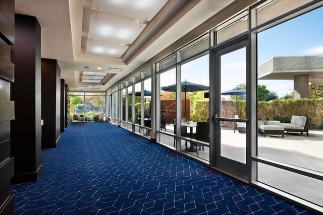 Meeting room with large glass doors, perfect for events and networking in San Jose.