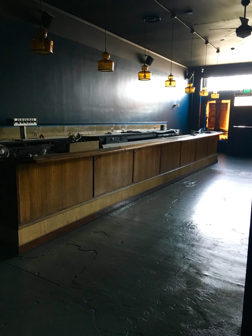 Spacious Ivy Room bar with wooden counter, perfect for event hosting and mingling.