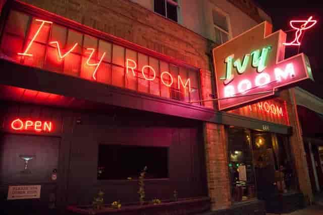Bar in Ivy Room with neon signage, perfect for social events and networking gatherings.