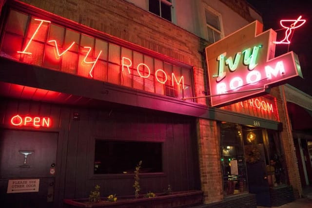 Bar in Ivy Room with neon signage, perfect for social events and networking gatherings.
