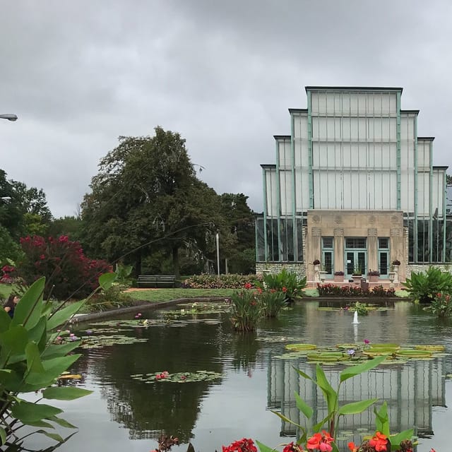 Jewel Box venue with glass structure amid lush gardens for outdoor events and receptions.