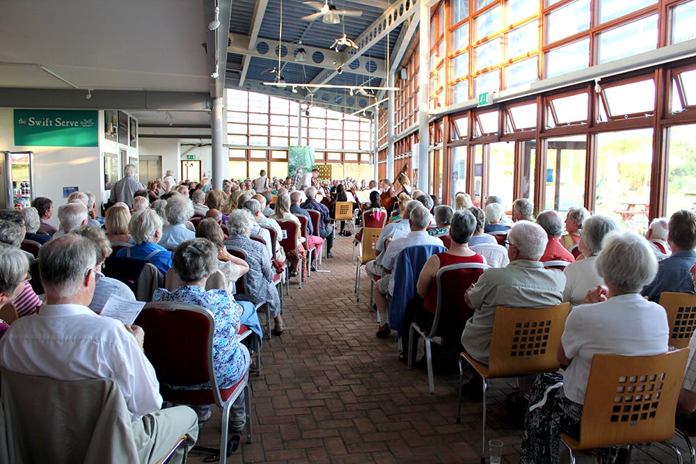 Lakeside View Room event with engaged audience and natural light for presentations.