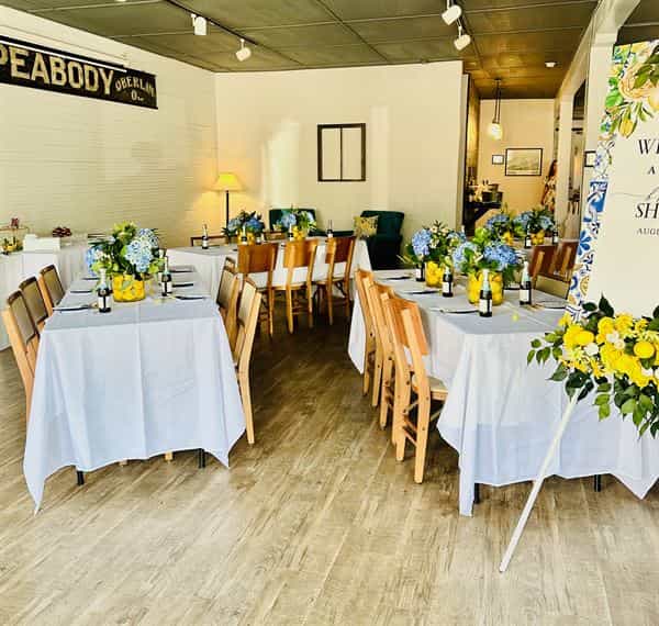 VIP Lounge event setup with elegant tables, floral decor, ideal for gatherings and celebrations.