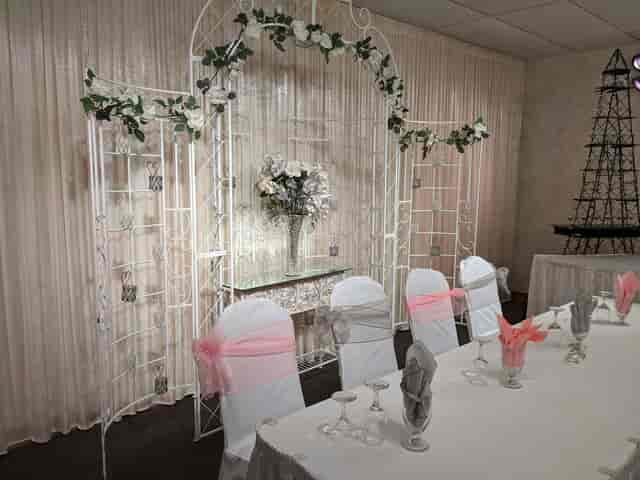 Grand Marquise Ballroom decorated for a wedding with floral arch and elegant table settings.