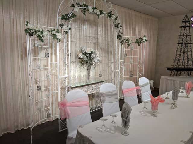 Grand Marquise Ballroom decorated for a wedding with floral arch and elegant table settings.