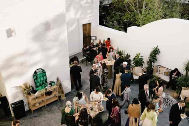 Vibrant outdoor celebration at Blanco Urban Venue with lush greenery and networking.