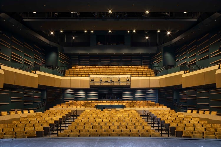 Multipurpose theater with tiered seating for conferences and performances in Sunset Lounge.