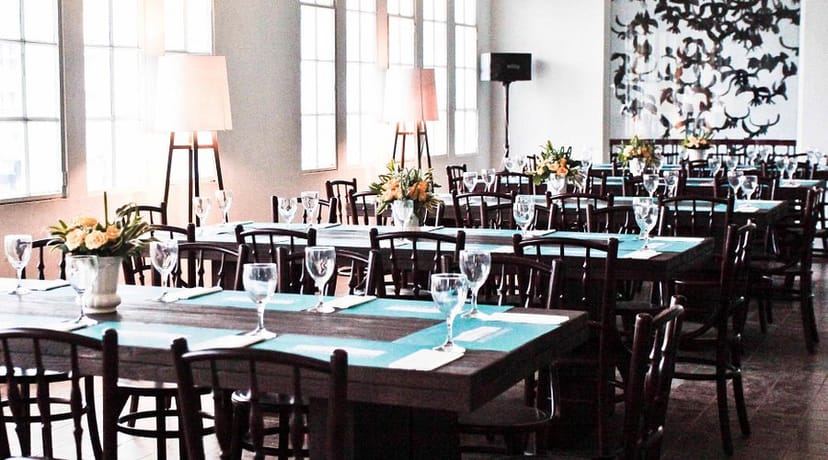 Elegant private dining room with natural light, perfect for formal gatherings and meetings.