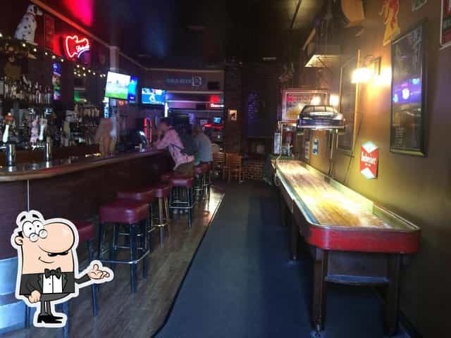 Cozy bar in The Orchid Room, with shuffleboard for networking events and gatherings.
