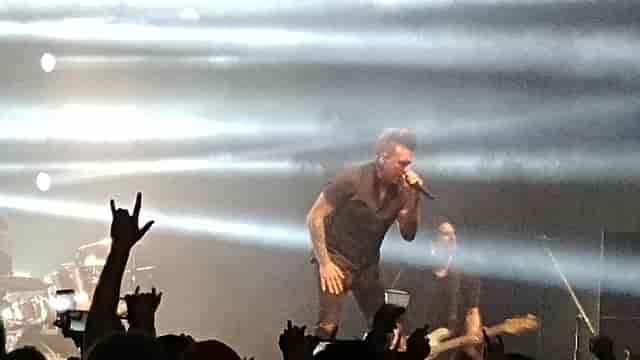 High-energy concert at Horizon Events Center with dramatic lighting and engaged crowd.
