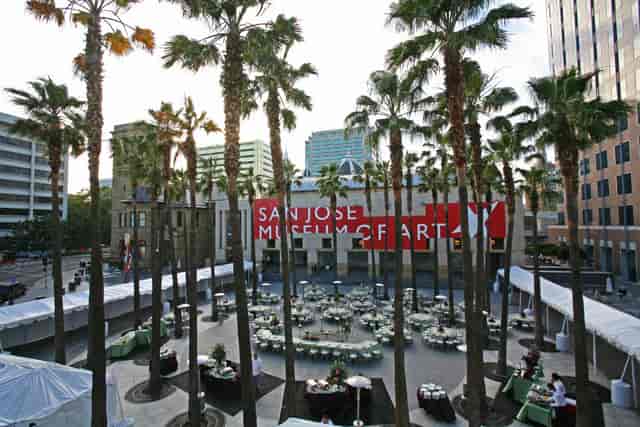 Elegant outdoor event space at San José Museum of Art with palm trees, perfect for corporate gatherings.