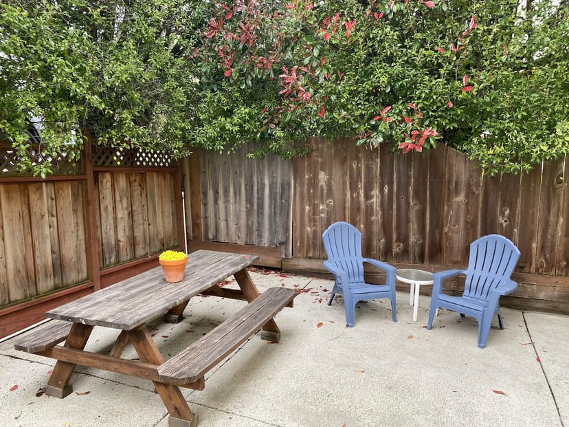 Back patio with rustic table, ideal for casual meetings and gatherings in San Jose.