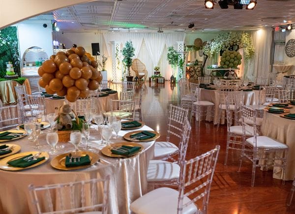 Elegant banquet hall with round tables and modern acrylic chairs for weddings and events.
