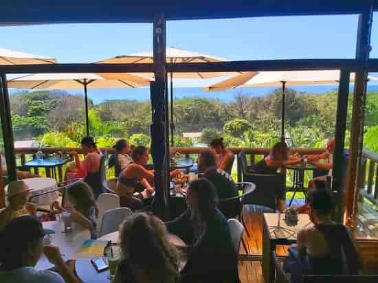 Organic restaurant at Horizon Hotel, vibrant outdoor seating with ocean views for events.