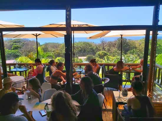 Organic restaurant at Horizon Hotel, vibrant outdoor seating with ocean views for events.
