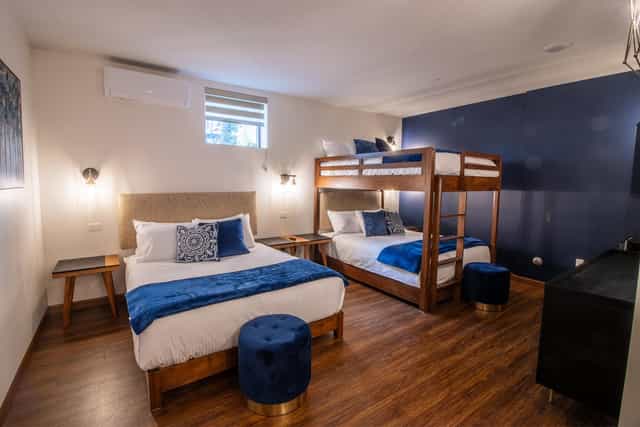 Retreat center hotel room with queen and bunk beds, perfect for family gatherings and events.