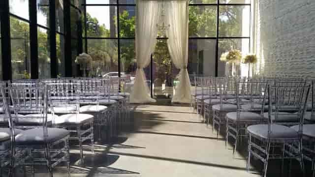 Outdoor patio at The GlassHouse with elegant Chiavari chairs, perfect for weddings and events.