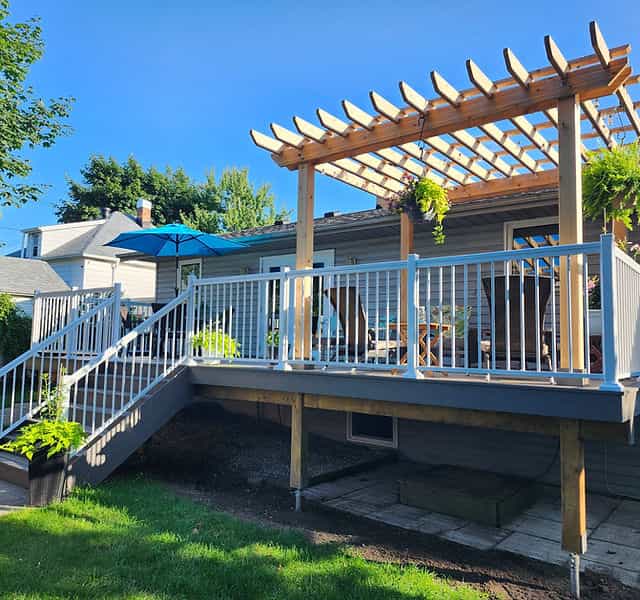 Charming patio and deck with pergola for outdoor social events at Casa Utopia Builders.