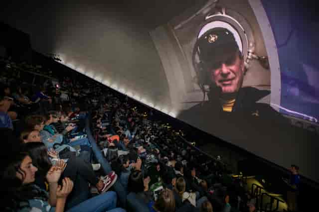 Packed IMAX Dome Theater at The Tech Interactive for an engaging hybrid event experience.