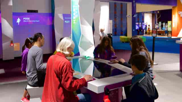 Interactive tech station in vibrant event space at The Tech Interactive.