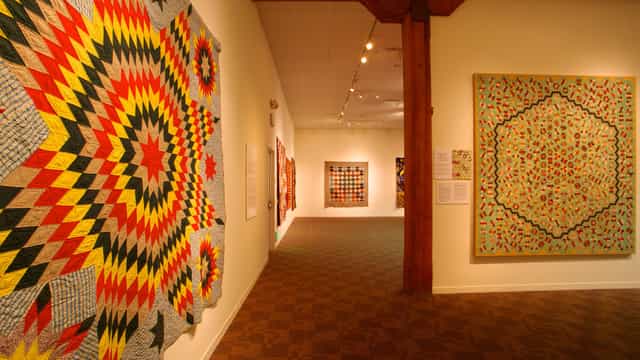 Vibrant gallery of colorful quilts in San Jose Museum, perfect for creative events and workshops.