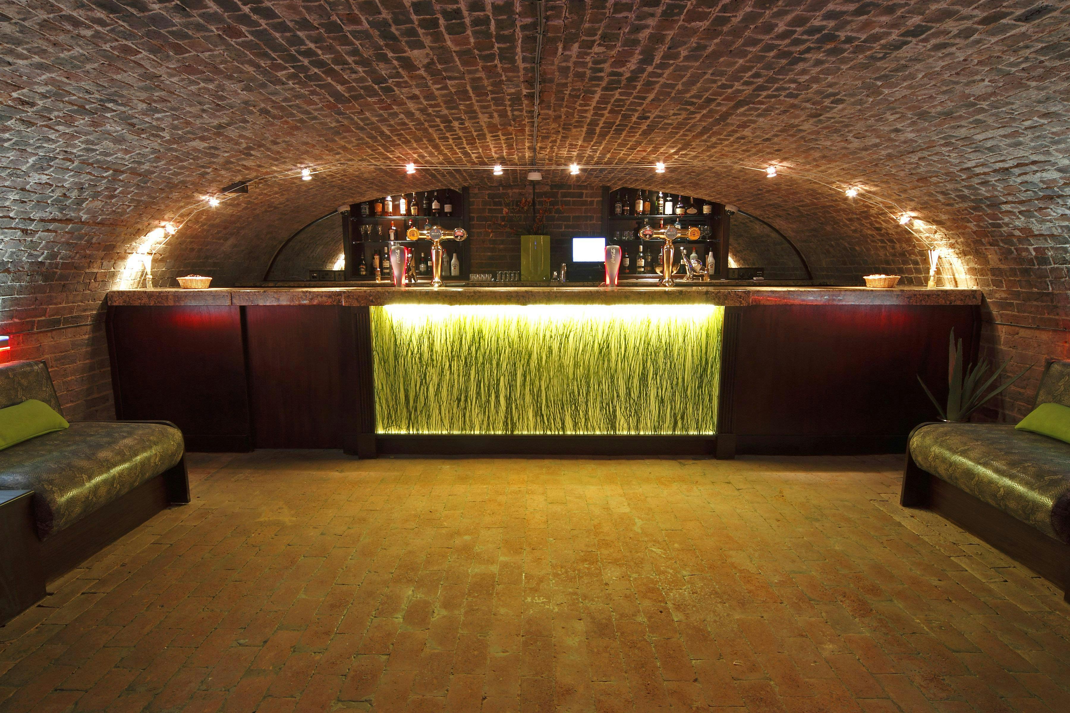 Stylish underground bar with brick archway, perfect for cocktail receptions in West Midlands.