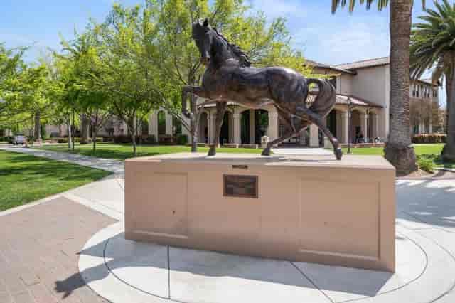 Horse statue in lush Santa Clara University outdoor space for events and receptions.