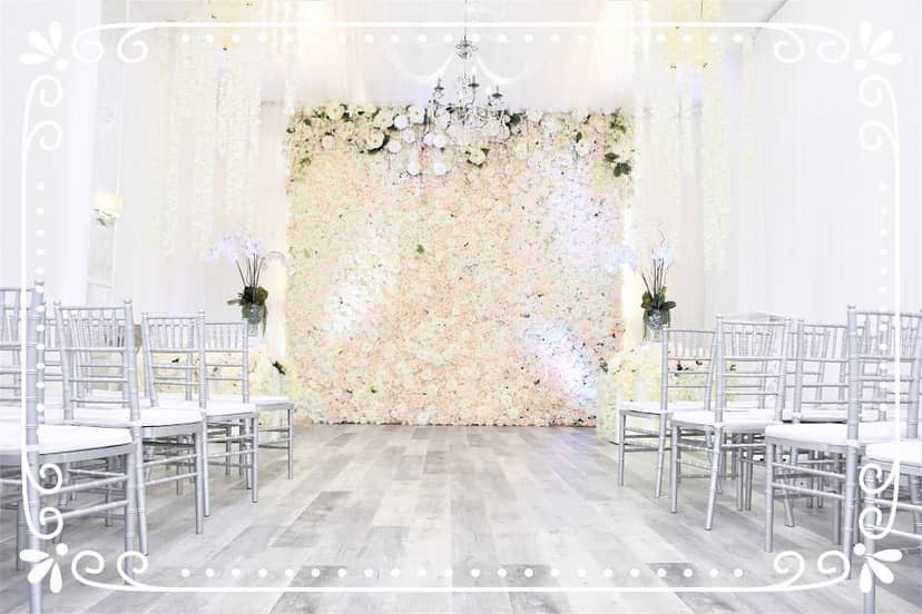 Elegant wedding reception at South Bay Event Center with floral backdrop and chic chairs.