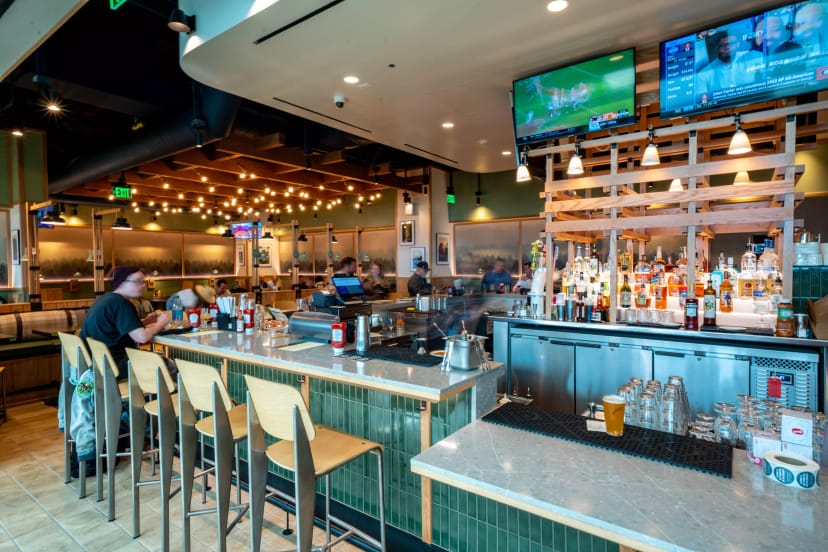 Dining area with stylish bar at Jim Stump's Taproom for events and casual gatherings.