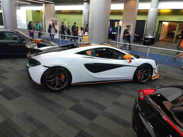 Sleek sports car display at San Jose convention center event for automotive enthusiasts.