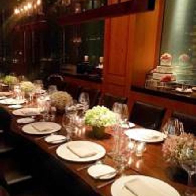 Elegant private dining room with floral centerpieces for corporate dinners.