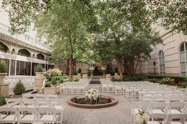 Garden Room at Hotel Crescent Court: elegant outdoor wedding venue with floral centerpiece.