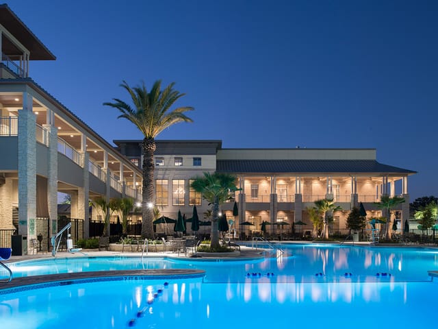 Elegant Wine Room venue with pool and palm trees, perfect for meetings and receptions.