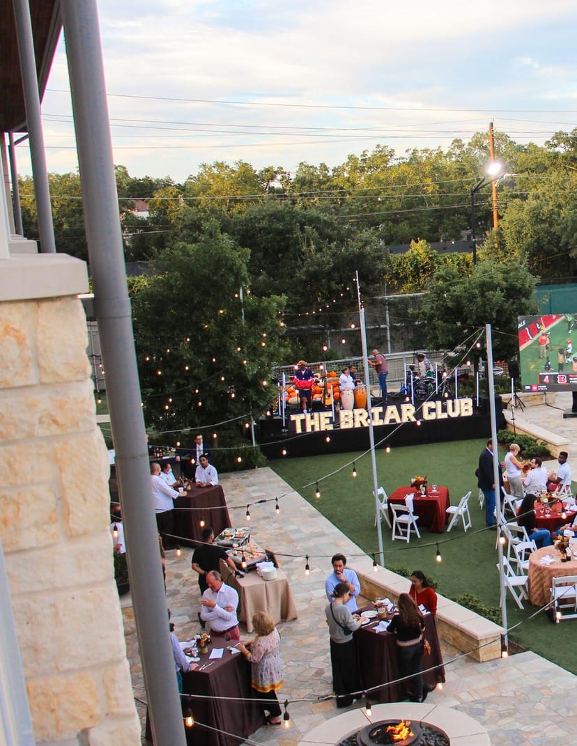 Elegant Magnolia Ballroom outdoor event with string lights for networking and dining.