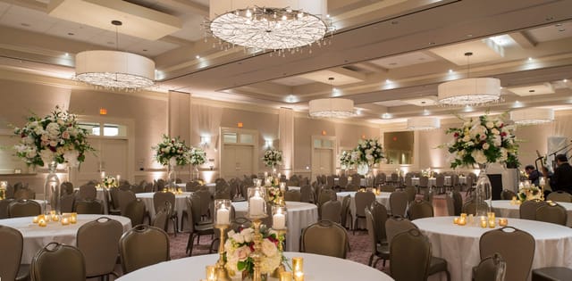 Elegant banquet hall at The Briar Club with floral centerpieces, perfect for weddings and corporate events.