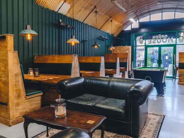 Stylish brewery taproom with wooden textures, ideal for networking events and gatherings.