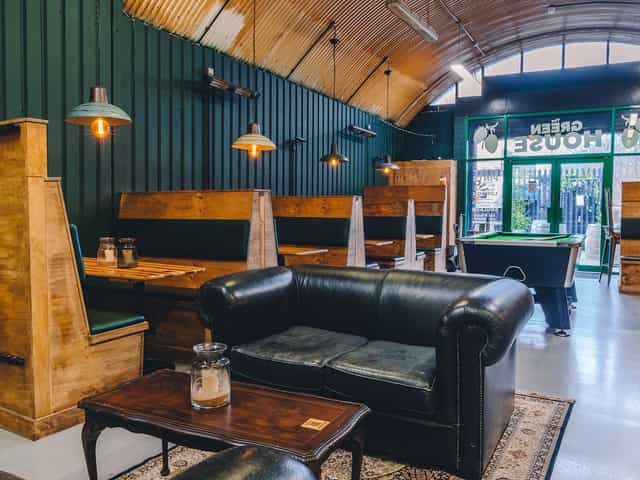 Stylish brewery taproom with wooden textures, ideal for networking events and gatherings.