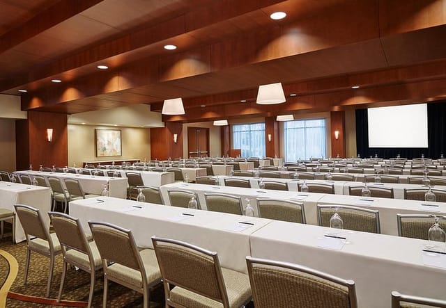 Charlie Conference Room with long tables, ideal for meetings and events.
