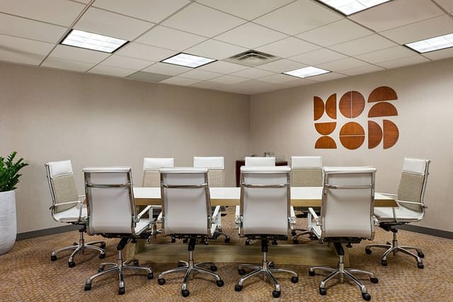 Modern Charlie Conference Room with round table, ideal for productive meetings.