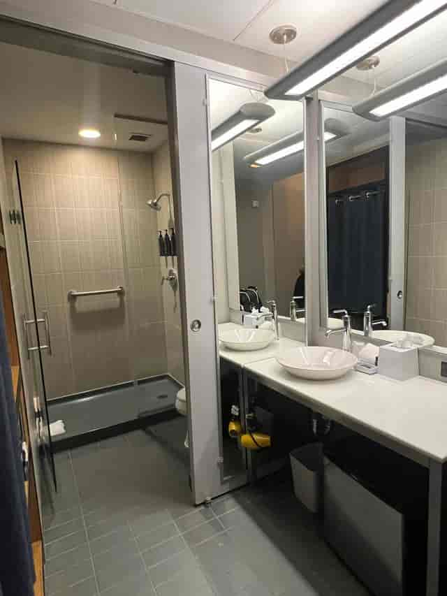 Modern restroom in Aloft Dallas Downtown with dual sinks for events and meetings.