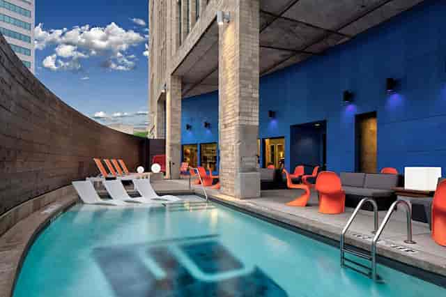 Modern outdoor event space with pool at Aloft Dallas Downtown, ideal for gatherings.