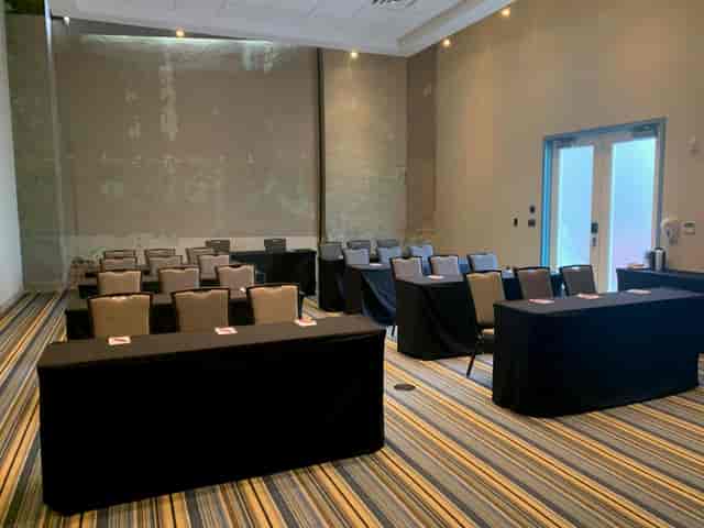 Aloft Dallas Downtown conference room set up with theater seating and modern decor.