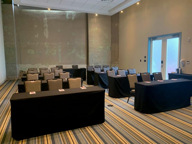 Aloft Dallas Downtown conference room set up with theater seating and modern decor.